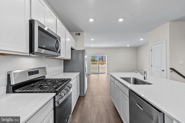 10604 Meridian Hill Way, Upper Marlboro, MD 20772 - kitchen featuring stainless steel appliances, a sink, wood finished floors, white cabinetry, and light countertops