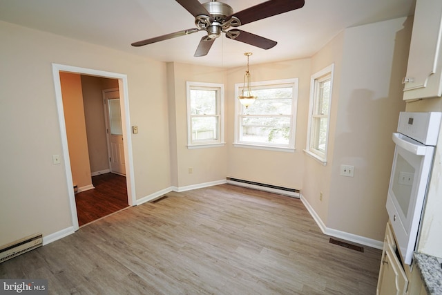 1206 Orchard Cir, Salisbury, MD 21801 - unfurnished dining area with baseboard heating, wood finished floors, a ceiling fan, and baseboards