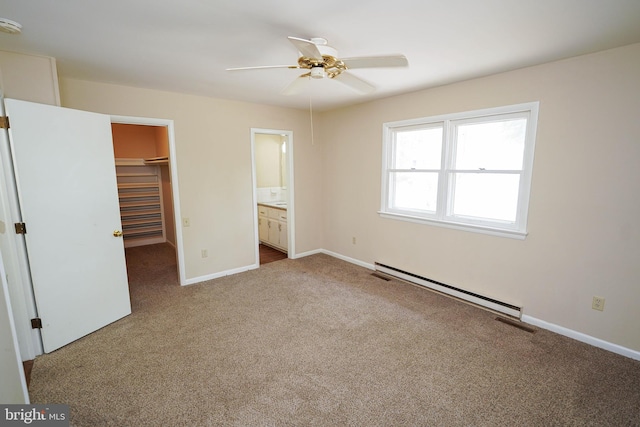 1206 Orchard Cir, Salisbury, MD 21801 - unfurnished bedroom featuring a baseboard heating unit, carpet, baseboards, a walk in closet, and a closet