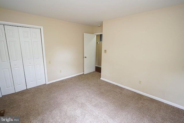 1206 Orchard Cir, Salisbury, MD 21801 - unfurnished bedroom featuring carpet flooring, a closet, and baseboards