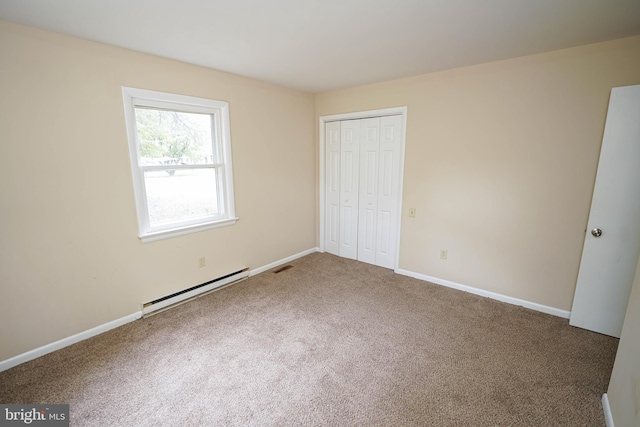 1206 Orchard Cir, Salisbury, MD 21801 - unfurnished bedroom with baseboard heating, carpet floors, a closet, and baseboards