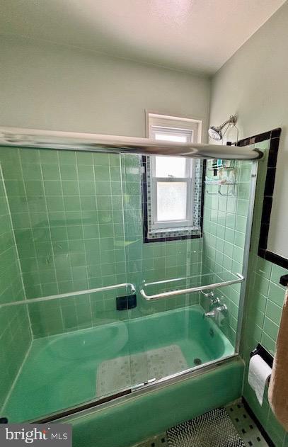 4116 Ellis St, Capitol Heights, MD 20743 - bathroom with combined bath / shower with glass door, tile patterned flooring, and tile walls