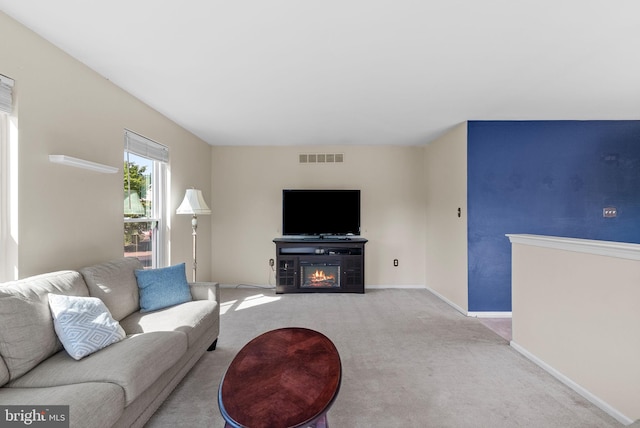 53 Pebble Beach Ln, Pottstown, PA 19464 - living area featuring carpet floors, a glass covered fireplace, and baseboards