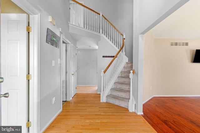 53 Pebble Beach Ln, Pottstown, PA 19464 - stairway featuring wood finished floors, baseboards, and a towering ceiling