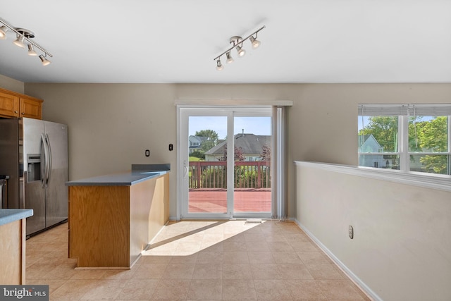 53 Pebble Beach Ln, Pottstown, PA 19464 - kitchen featuring rail lighting, stainless steel fridge with ice dispenser, baseboards, and brown cabinets