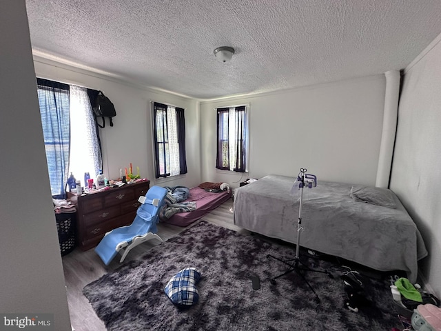 202 N Penn St, York, PA 17401 - bedroom with wood finished floors and a textured ceiling