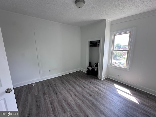 202 N Penn St, York, PA 17401 - unfurnished bedroom with a textured ceiling, dark wood-style floors, a closet, and baseboards
