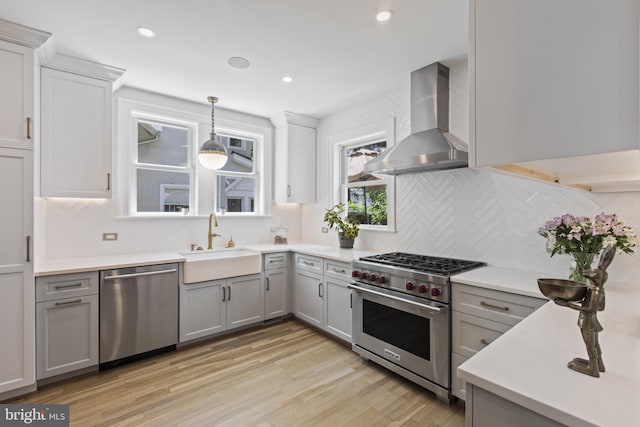 6200 Broad Branch Rd NW, Washington, DC 20015 - kitchen with stainless steel appliances, wall chimney exhaust hood, a sink, gray cabinets, and light countertops