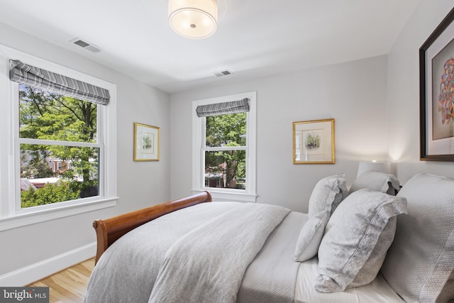 6200 Broad Branch Rd NW, Washington, DC 20015 - bedroom featuring multiple windows, light wood-style floors, and baseboards