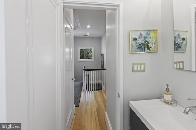 6200 Broad Branch Rd NW, Washington, DC 20015 - corridor featuring light wood-style floors, attic access, a sink, an upstairs landing, and baseboards