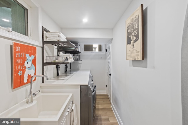 6200 Broad Branch Rd NW, Washington, DC 20015 - laundry area with cabinet space, wood finished floors, washing machine and clothes dryer, and baseboards