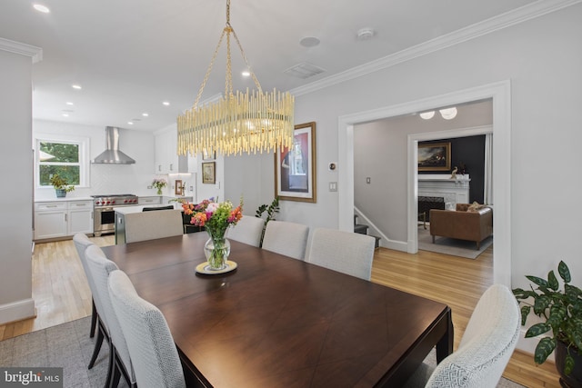 6200 Broad Branch Rd NW, Washington, DC 20015 - dining space with stairs, ornamental molding, light wood-type flooring, a fireplace, and a chandelier