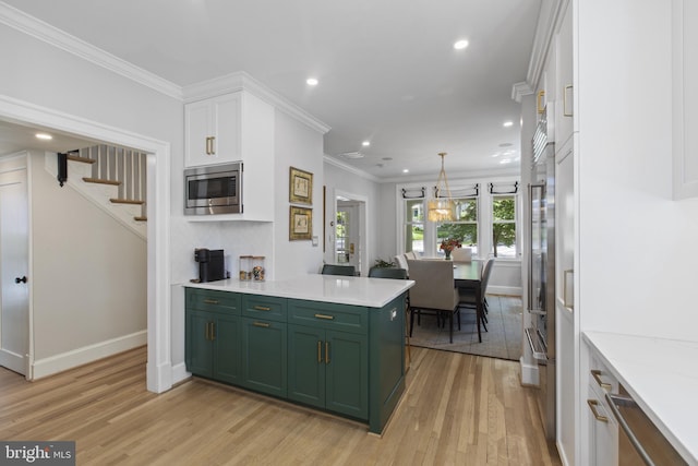 6200 Broad Branch Rd NW, Washington, DC 20015 - kitchen with green cabinets, stainless steel microwave, light wood-style floors, white cabinetry, and recessed lighting