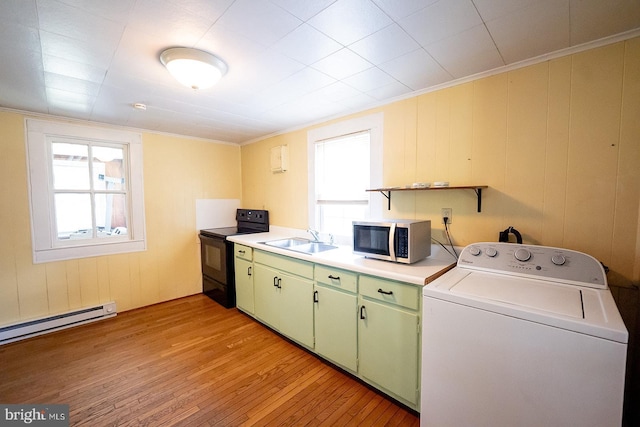 2570 Hickman Ln, Nanticoke, MD 21840 - laundry area featuring washer / clothes dryer, light wood finished floors, crown molding, and a baseboard heating unit