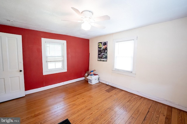 2570 Hickman Ln, Nanticoke, MD 21840 - empty room featuring plenty of natural light, light wood-style floors, baseboards, and a ceiling fan