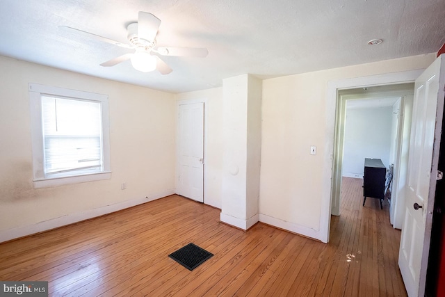 2570 Hickman Ln, Nanticoke, MD 21840 - unfurnished bedroom featuring baseboards, light wood finished floors, a ceiling fan, and a closet