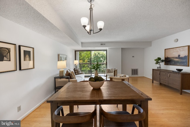 3800 Powell Ln Unit 629, Falls Church, VA 22041 - dining room with a textured ceiling, light wood-style floors, and baseboards