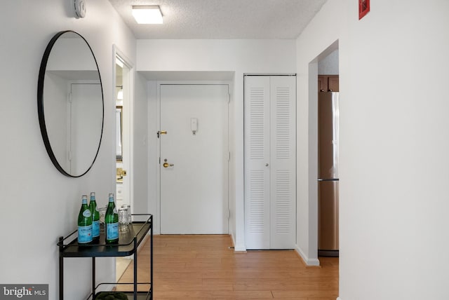 3800 Powell Ln Unit 629, Falls Church, VA 22041 - hallway with light wood-style floors and a textured ceiling