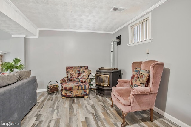 9803 Luke Ct, Upper Marlboro, MD 20772 - living area featuring a wood stove, wood finished floors, and crown molding