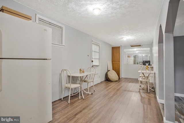 9803 Luke Ct, Upper Marlboro, MD 20772 - kitchen with freestanding refrigerator, a textured ceiling, and wood finished floors