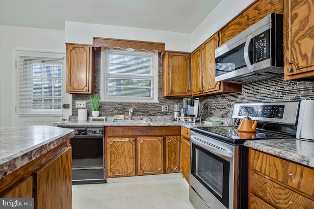 9803 Luke Ct, Upper Marlboro, MD 20772 - kitchen with stainless steel appliances, light flooring, decorative backsplash, and healthy amount of natural light