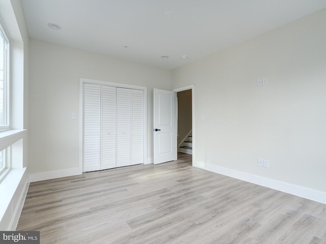 632 Moyer St, Philadelphia, PA 19125 - unfurnished bedroom featuring wood finished floors, a closet, baseboards, and multiple windows