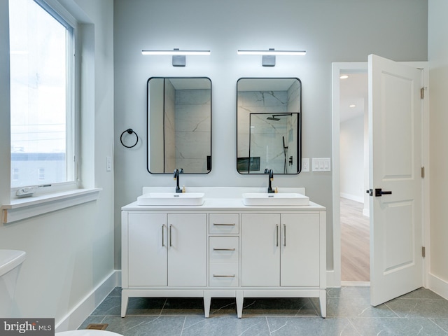 632 Moyer St, Philadelphia, PA 19125 - bathroom with baseboards, double vanity, walk in shower, and plenty of natural light