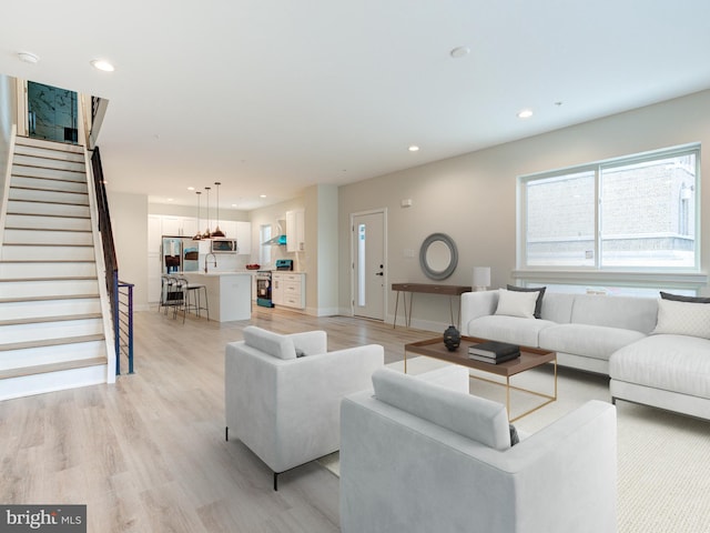 632 Moyer St, Philadelphia, PA 19125 - living area featuring recessed lighting, light wood finished floors, stairs, and baseboards