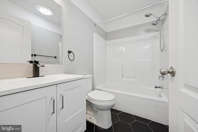 2601 Pickwick St, Philadelphia, PA 19134 - bathroom with vanity, toilet, shower / washtub combination, tile patterned flooring, and decorative backsplash