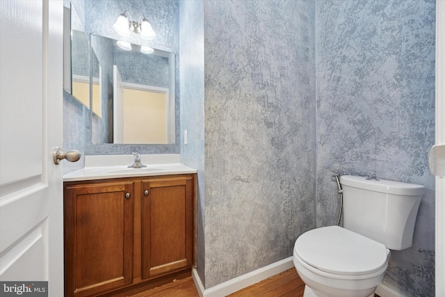 2601 Pickwick St, Philadelphia, PA 19134 - bathroom with wood finished floors, vanity, toilet, and baseboards