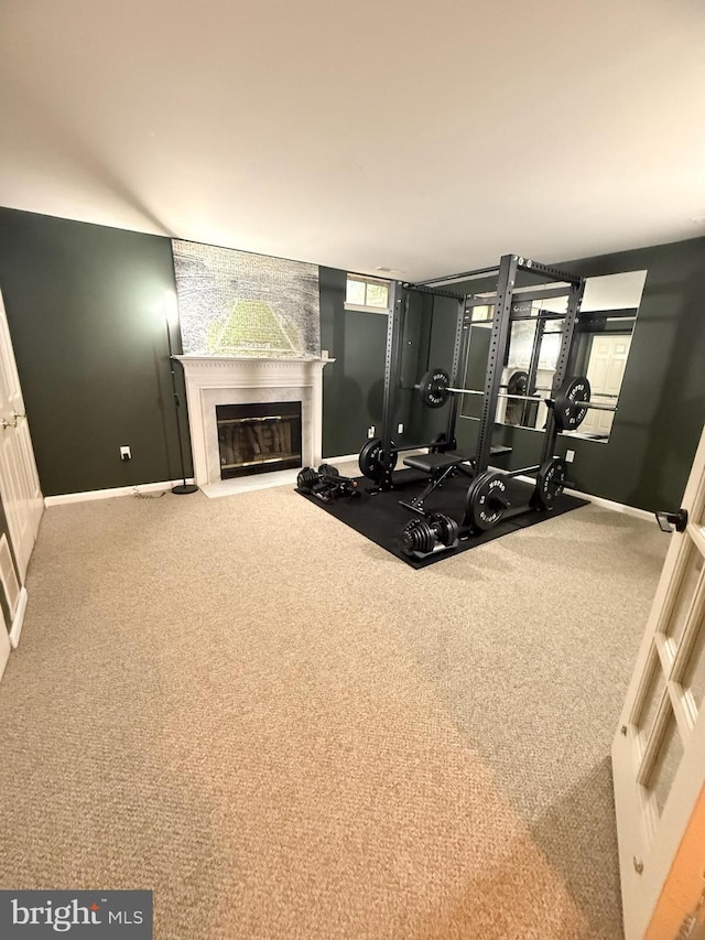 14926 Dunvegan Ct, Silver Spring, MD 20906 - workout area featuring baseboards, a fireplace with flush hearth, and carpet