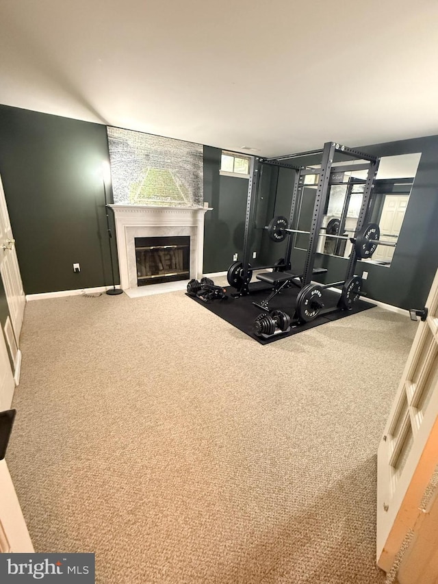 14926 Dunvegan Ct, Silver Spring, MD 20906 - exercise room featuring baseboards, a fireplace with flush hearth, and carpet