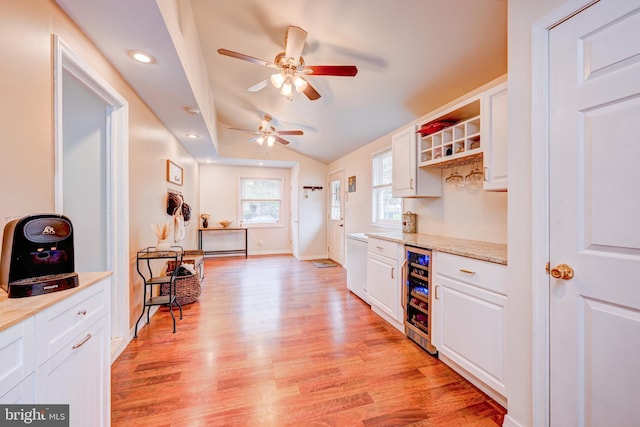 54 Camellia Rd, Levittown, PA 19057 - bar with wine cooler, light wood finished floors, a ceiling fan, vaulted ceiling, and baseboards