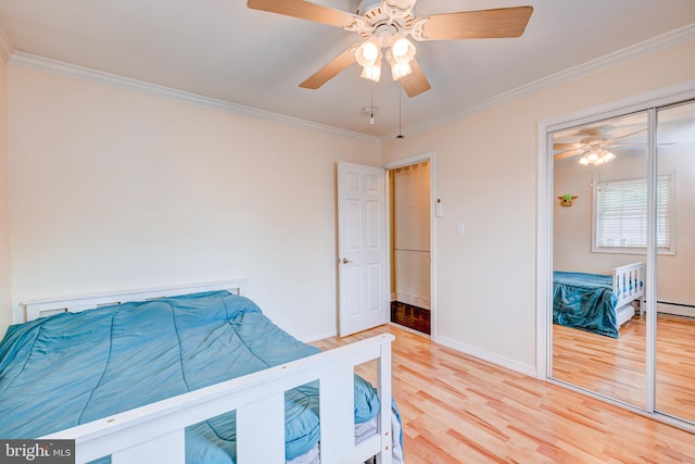 54 Camellia Rd, Levittown, PA 19057 - bedroom featuring light wood finished floors, ornamental molding, baseboards, a ceiling fan, and a baseboard radiator