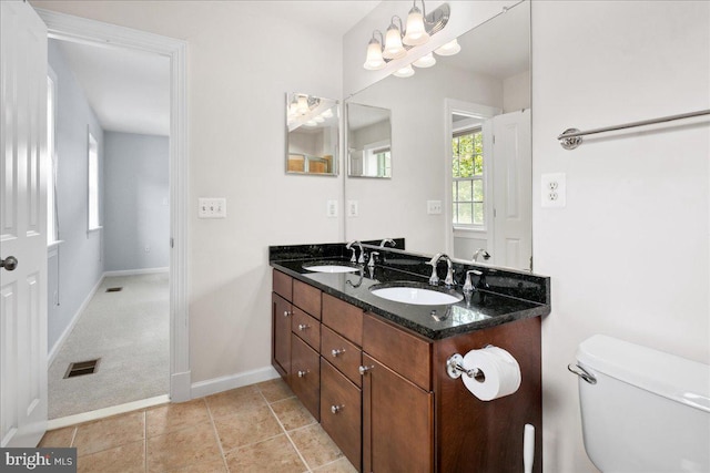 3427 Ramsgate Ter, Alexandria, VA 22309 - full bath featuring double vanity, toilet, baseboards, and tile patterned flooring