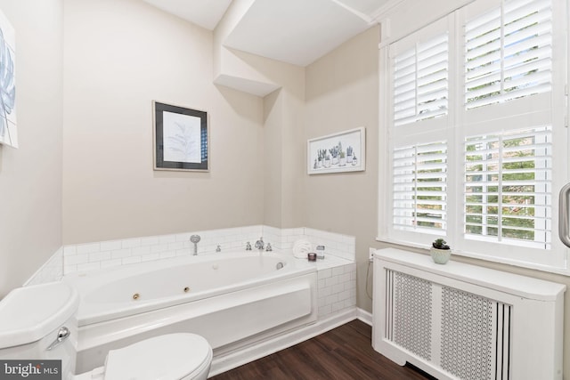 858 S Front St, Philadelphia, PA 19147 - full bath with radiator heating unit, toilet, a whirlpool tub, and wood finished floors