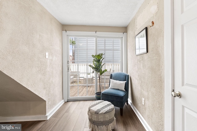 858 S Front St, Philadelphia, PA 19147 - living area with wood finished floors, a textured wall, baseboards, and a textured ceiling