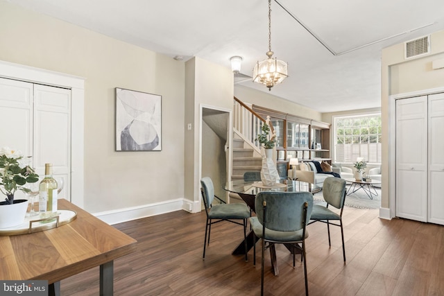 858 S Front St, Philadelphia, PA 19147 - dining room with stairway, dark wood-style flooring, a chandelier, and baseboards