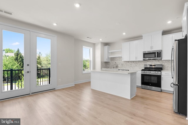 43288 Farringdon Sq, Broadlands, VA 20148 - kitchen featuring stainless steel appliances, backsplash, light wood-type flooring, light countertops, and recessed lighting