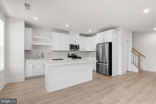 43288 Farringdon Sq, Broadlands, VA 20148 - kitchen with stainless steel appliances, light countertops, decorative backsplash, a center island, and recessed lighting