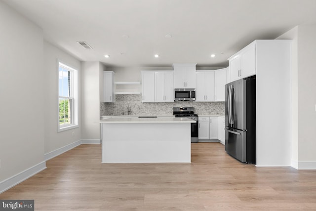 43288 Farringdon Sq, Broadlands, VA 20148 - kitchen with stainless steel appliances, backsplash, light countertops, a sink, and white cabinetry