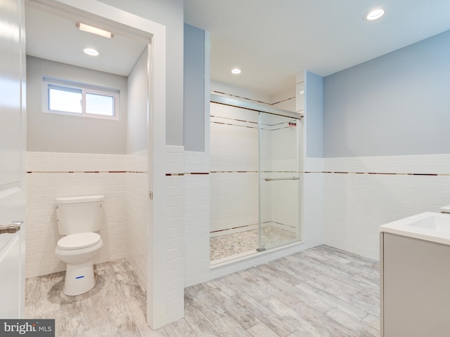 719 Cantrell St, Philadelphia, PA 19148 - bathroom featuring tile walls, a wainscoted wall, toilet, a shower stall, and vanity