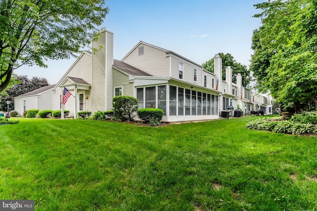 1827 Wexford Rd, Palmyra, PA 17078 - back of property featuring a sunroom, a chimney, and a lawn