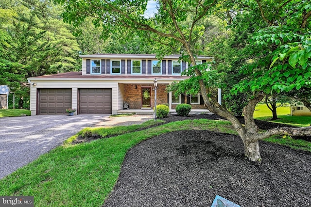 22 Woodholme Village Ct, Baltimore, MD 21208 - view of front of property featuring driveway, a porch, and a garage