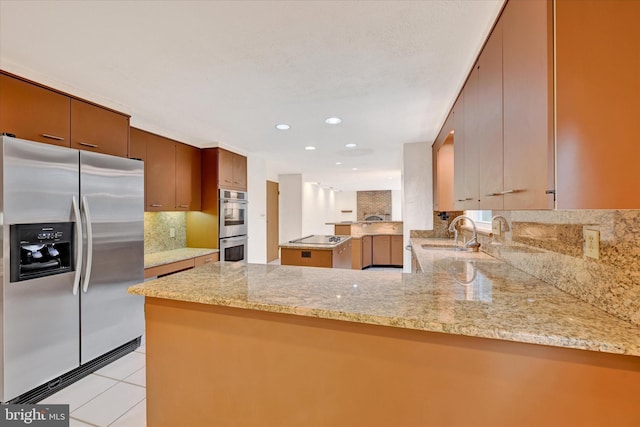 22 Woodholme Village Ct, Baltimore, MD 21208 - kitchen with stainless steel appliances, a sink, a peninsula, tasteful backsplash, and light stone countertops