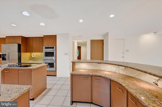 22 Woodholme Village Ct, Baltimore, MD 21208 - kitchen featuring stainless steel appliances, brown cabinets, recessed lighting, light tile patterned flooring, and light stone counters