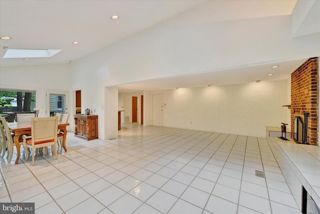 22 Woodholme Village Ct, Baltimore, MD 21208 - living area featuring a skylight, high vaulted ceiling, a fireplace, recessed lighting, and light tile patterned flooring