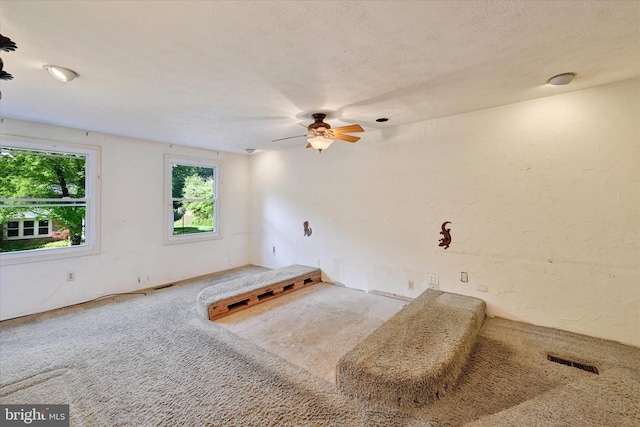 22 Woodholme Village Ct, Baltimore, MD 21208 - carpeted empty room featuring healthy amount of natural light, a ceiling fan, and a textured wall