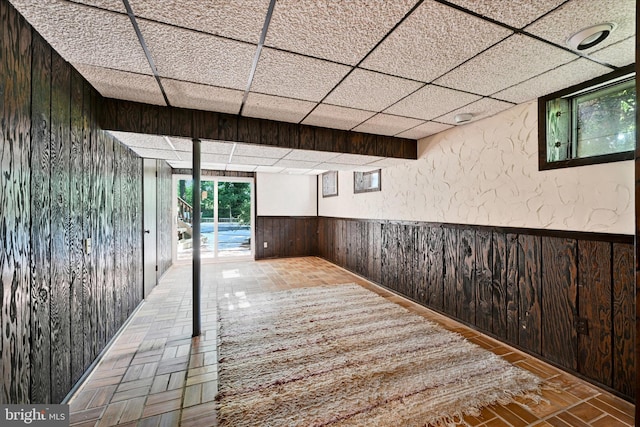 22 Woodholme Village Ct, Baltimore, MD 21208 - hallway with wooden walls, a paneled ceiling, and a wainscoted wall