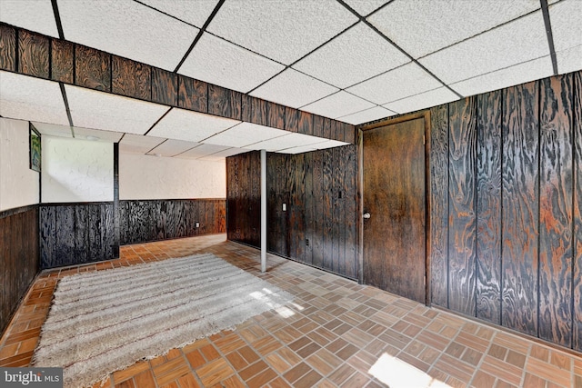22 Woodholme Village Ct, Baltimore, MD 21208 - finished below grade area with wood walls, a drop ceiling, a wainscoted wall, and brick patterned floors